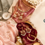 Gold and pearl jewelry arranged on silk fabrics with flowers, featuring CHAHAT STUDIO logo on the right.